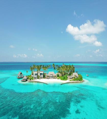 Aerial view of Cheval Blanc Randheli Private Island resort surrounded by turquoise water in the Maldives