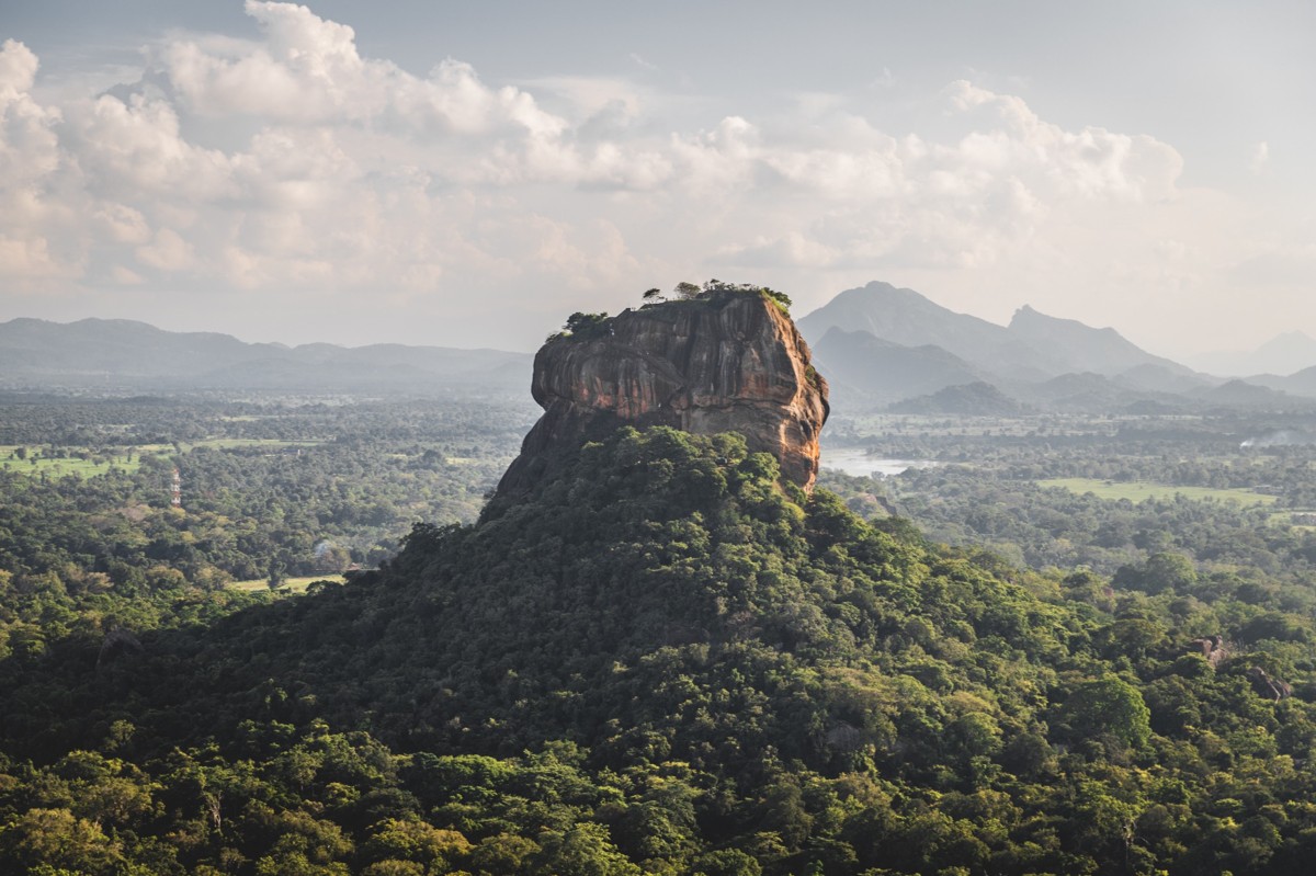 Aerial view of Sigiriya Lion Rock rising above lush green jungle landscape in Sri Lanka